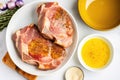 uncooked pork chop with a bowl of honey mustard sauce next to it Royalty Free Stock Photo