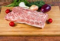Uncooked pork loin and fresh vegetables on the cutting board Royalty Free Stock Photo
