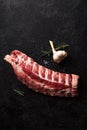 Uncooked pork ribs on dark textured background Royalty Free Stock Photo