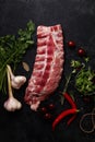 Uncooked pork ribs on dark textured background Royalty Free Stock Photo