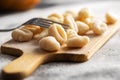 Uncooked potato gnocchi on cutting board. Tasty italian food