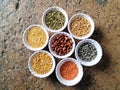 Uncooked pulses,grains and seeds in White bowls over ston background. selective focus Royalty Free Stock Photo