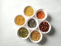 Uncooked pulses,grains and seeds in White bowls over ston background. selective focus Royalty Free Stock Photo