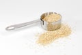 Uncooked quinoa with metal measuring cup Royalty Free Stock Photo