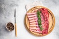 Uncooked rack of lamb, raw mutton chops on wooden board. grey background. top view Royalty Free Stock Photo