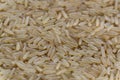 Uncooked raw long brown rice grains background, top view Royalty Free Stock Photo