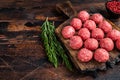 Uncooked Raw meatballs from ground beef and pork meat with rosemary. Dark Wooden background. Top view. Copy space Royalty Free Stock Photo