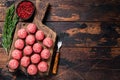 Uncooked Raw meatballs from ground beef and pork meat with rosemary. Dark Wooden background. Top view. Copy space Royalty Free Stock Photo