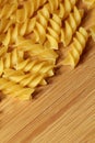 Uncooked raw pasta background on wooden background