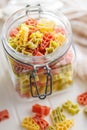 Uncooked raw pasta. Various Christmas shapes. Pasta in jar on white table Royalty Free Stock Photo