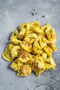 Uncooked raw ravioli with Mozzarella and Tomato. Gray background. Top view Royalty Free Stock Photo