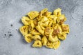 Uncooked raw ravioli with Mozzarella and Tomato. Gray background. Top view Royalty Free Stock Photo