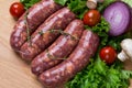 Uncooked raw sausages on wooden board Royalty Free Stock Photo