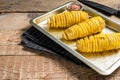 Uncooked raw Tornado or Twist potato fries. Wooden background. Top view. Copy space Royalty Free Stock Photo