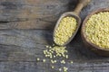 Uncooked raw yellow lentil in wooden shovel and bowl on wooden rustic table Royalty Free Stock Photo