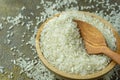 uncooked rice or dry rice. raw rice in wooden bowl with wooden spoon and fork Royalty Free Stock Photo
