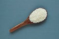 Uncooked rice, jasmine rice, mali rice,Thai jasmine rice in a wood ladle on white background