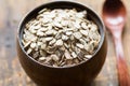 Uncooked rolled oats in wooden bowl Royalty Free Stock Photo