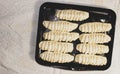 Uncooked rolls with yeast dough on a baking sheet. Homemade cake Royalty Free Stock Photo