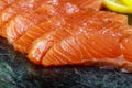 Uncooked salmon fish fillet with avocado, on marble plate, top view ingredients ready to eat Royalty Free Stock Photo
