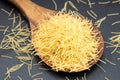 Uncooked soup noodle pasta in wooden spoon Royalty Free Stock Photo
