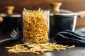 Uncooked spaetzle pasta in jar on kitchen table Royalty Free Stock Photo