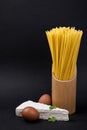 Spaghetti pasta with eggs and cheese on black background, copy space Royalty Free Stock Photo