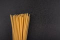 Uncooked spaghetti on gray background close. Cook background. Italian cuisine