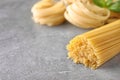 Uncooked spaghetti on grey table. Italian pasta