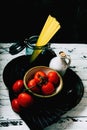 Uncooked spaghetti,  organic tomatoes and jug of olive oil Royalty Free Stock Photo