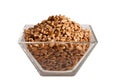 Uncooked Spelt in glass bowl, isolated