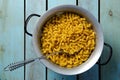 Uncooked spiral pasta with a spoon in a strainer. Royalty Free Stock Photo