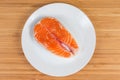 Uncooked steak of arctic char on dish on wooden surface Royalty Free Stock Photo