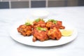 uncooked tandoori chicken thighs on a white plate