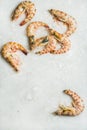 Uncooked tiger prawns on chipped ice over grey background Royalty Free Stock Photo