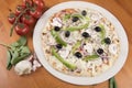 Uncooked vegetarian pizza with olives, peppers, onion, mushrooms and garlic Royalty Free Stock Photo