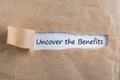 Uncover The Benefits text on brown envelope. Word Uncover The Benefits on torn paper. Concept Image. Royalty Free Stock Photo