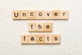uncover the fact word written on wood block. uncover the fact text on table, concept Royalty Free Stock Photo