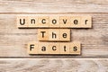 Uncover the fact word written on wood block. uncover the fact text on table, concept Royalty Free Stock Photo