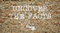 Uncover the facts is shown using the text and picture of the lamp on the wall Royalty Free Stock Photo