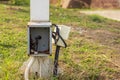 The uncovered rusted electric box looks unsafe