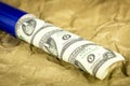 Uncut sheet of money in a blue tube