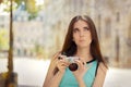 Undecided Girl with Compact Digital Camera Royalty Free Stock Photo