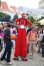 Undecided red clown on stilts