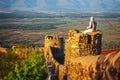 undefiened tourist looks at part of the city wall with fortified tower in historical town Signagi, Kakheti region, Georgia Royalty Free Stock Photo