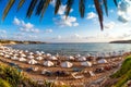 Undefinable Tourists relaxing on the beach in the summer vacation. Peyia vil