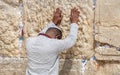 Undefined afro-american young man pray at the Western Wall. Jerusalem