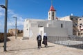 Undefined Arabian women walk next to St. John Baptist Catholic Church at old Acre city