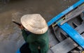 An undefined boatwoman, rowing a wooden boat. Vietnam