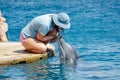 The undefined girl trainer with dolphin at the Dolphin Reef in Eilat, on the shores of the Red Sea